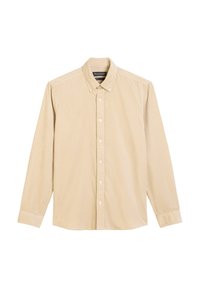 Chemise boutonnée en velours côtelé beige à manches longues avec un col à boutons et une étiquette sur la poche avant.