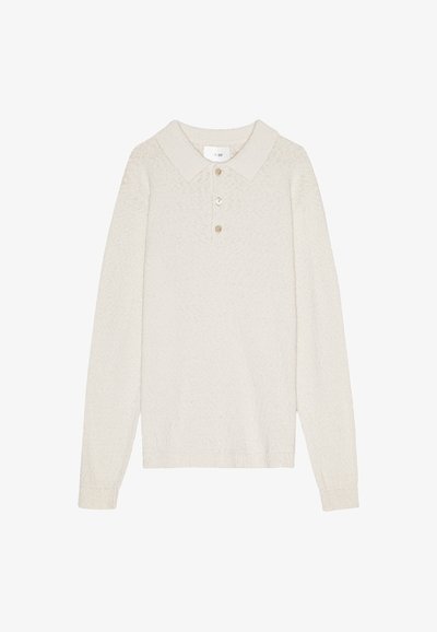 Langärmliges, cremefarbenes Poloshirt aus strukturiertem Stoff, mit spitzem Kragen und einer Knopfleiste mit drei Knöpfen.
