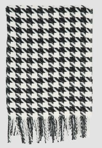 Zwart-witte houndstooth-patroon sjaal, gemaakt van geweven stof met franjes langs de onderste randen. Zachte textuur.