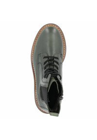 Green leather ankle boot with a round toe, lace-up closure, contrasting brown sole, and black elastic side panel for easy wear.