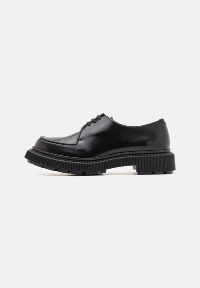 Black leather derby shoes with a smooth finish, rounded toe, thick ribbed sole, and four eyelets for laces. Side view.