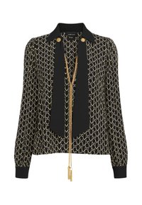 Blusa nera con catena dorata e motivo geometrico, maniche lunghe, colletto a cravatta nera e decorazioni con bottoni dorati sullo scollo.