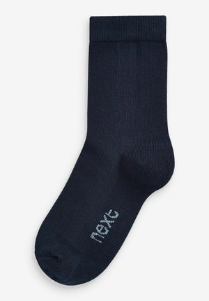 Navyblå bomuldsstrømpe med ribbet tekstur, der har et lys gråt logo nær tåen. Standard længde med forstærket hæl og tå.