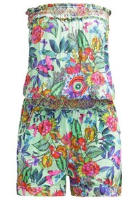 Combinaison sans bretelles à motif floral avec des fleurs colorées, des feuilles et des papillons sur un tissu vert clair, avec une taille et un bord supérieur smockés.