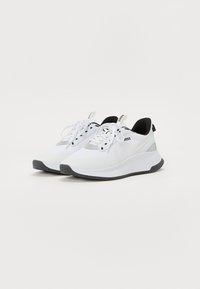White athletic shoes with a breathable mesh upper, lace closure, and black accents. Textured sole for grip and stability.