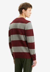 Maroon and gray striped sweater made of soft fabric, featuring a crew neck and ribbed cuffs and hem, shown from the back.