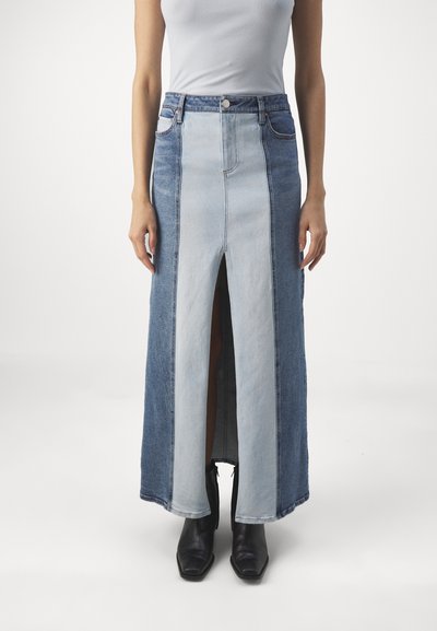 Denim maxi skirt featuring a color-block design in light and dark blue tones, with a front slit and five-pocket styling.