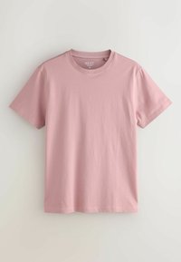 T-shirt slim à manches courtes de couleur rose clair unie, col rond, taille moyenne, présenté à plat sur un fond clair.
