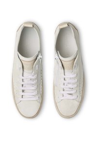 White suede sneakers with white laces, a side zipper, and perforated detailing. Features a beige accent on the tongue and light rubber sole.