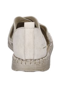 Krémové nazouvací boty s plátěným svrškem, elastickými boky, texturovanou podrážkou a prošitím podél okraje. Zakulacený design v zadní části.
