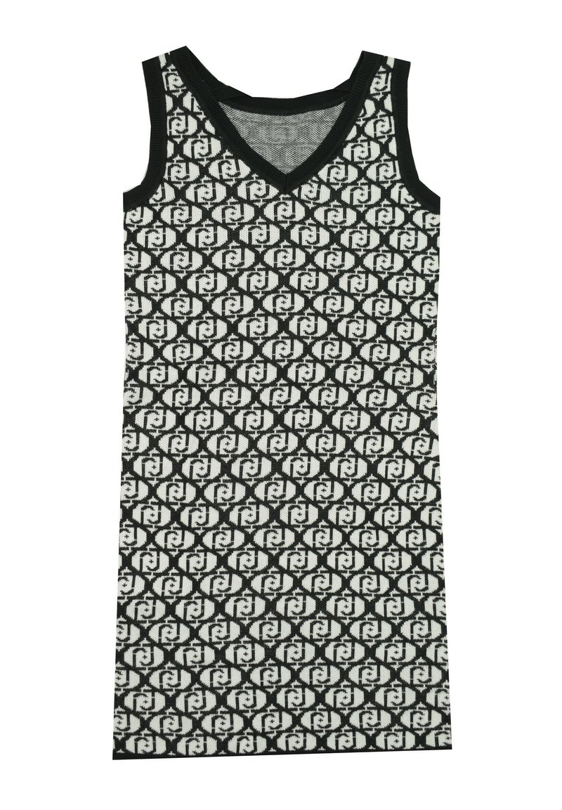 Abito lavorato a maglia bianco e nero con scollatura a V, senza maniche e un motivo geometrico ripetuto su tutta la stoffa.
