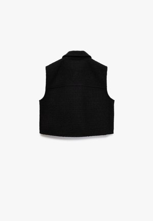 Mustaton hihaton liivi, joka on valmistettu teksturoidusta kankaasta. Varustettu kauluksella ja takapaneelilla, suora helma ja siistit linjat.