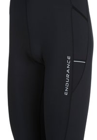 Svarta sportleggings med en slät yta, med en reflekterande rand och "ENDURANCE" tryckt i vitt på sidan.