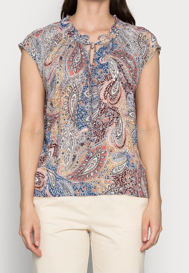 Kortärmad blus med ett paisleymönster i nyanser av blått, rött och beige, med en rynkad halsringning och knytdetalj.
