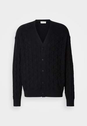 Black knitted cardigan featuring a diamond pattern, V-neck, button front closure, and ribbed cuffs and hem.