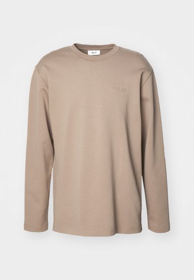 Long-sleeve beige cotton shirt with a crew neck. Features embroidered text "NN. 07" on the chest, soft texture, and relaxed fit.