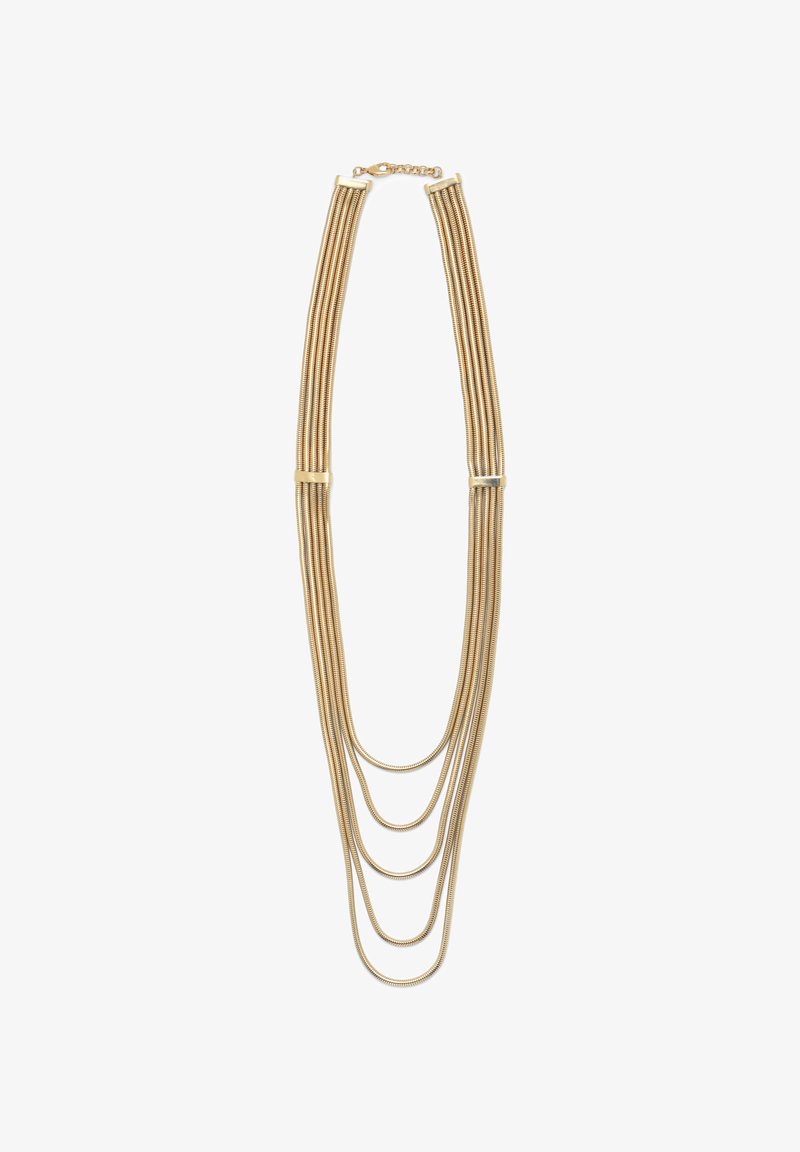 Auksinės spalvos daugiagyslė kaklo grandinėlė su keturiomis ilgio kaskadomis, pagamintomis iš lanksčių gyvačių grandinėlių. Užsegimas gale leidžia reguliuoti ilgį.