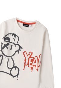 Camicia bianca a maniche lunghe con grafica di orso nero e testo rosso "YEAH". Presenta un collo rotondo e un'accentuazione arancione sul colletto. Materiale di cotone morbido.