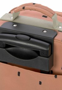 Orangefarbener Stoffkoffer mit strukturierter Oberfläche, ausgestattet mit einem schwarzen Kunststoffgriff mit Knopf, akzentuiert durch kleine schwarze geometrische Muster.