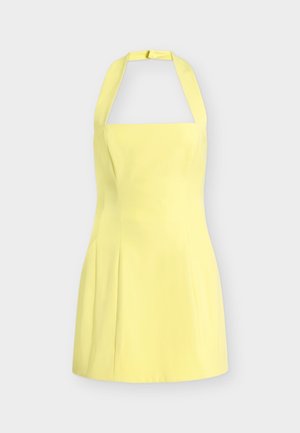 Μαν sleeveless κίτρινο φόρεμα με λαιμόκοψη halter, εφαρμοστό μπούστο και φούστα που ανοίγει, παρουσιάζεται σε απλό ανοιχτό γκρι φόντο.