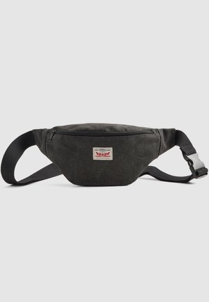 Black fabric waist bag with adjustable strap, front zipper pocket, and small Levi Strauss & Co. logo patch on center front.
