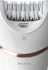 Épilateur électrique avec un boîtier en plastique blanc, des accents dorés roses et une tête texturée dotée de plusieurs pinces blanches pour l'épilation.