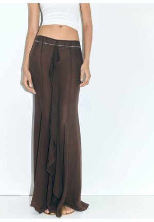 Brown maxi skirt in lightweight fabric, featuring a cascading ruffle detail, a fitted waist, and a subtle silver accent at the waistband.