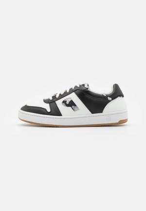 Black and white leather sneaker with round toe, rubber sole, and lace-up design; features a patterned accent on the side.