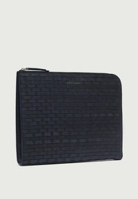 Custodia per laptop in pelle intrecciata nera con superficie texturizzata e chiusura con zip. Presenta un logo sobrio impresso nella parte anteriore.