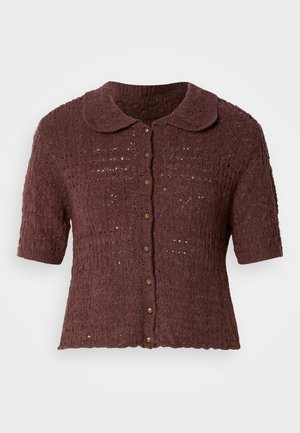 Short-sleeved burgundy cardigan with a textured knit pattern, scalloped hem, and a rounded collar featuring brown buttons down the front.