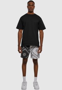 Karl Kani SMALL SIGNATURE PAISLEY BLOCK RESORT - Treniņtērpa apakšdaļas - black white