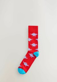 Chaussette en coton rouge ornée d'un motif de dinosaures stégosaures violets clairs, avec des accents turquoise au talon et à la pointe.