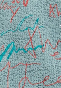 Textured fabric in light teal, featuring irregular red and blue scribbles and lines, creating an abstract design with a tactile surface.
