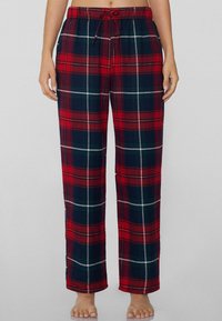 Rode en marineblauwe geruite pyjamabroek met een elastische tailleband en trekkoord. Glad stof met een ontspannen rechte pijp.