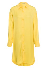 Chemise jaune surdimensionnée en tissu lisse, dotée d'un devant à boutons, de manches longues et d'un ourlet arrondi. Aucun motif ni texture visible.