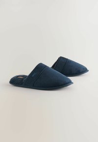 Navy blue slippers with a soft textile upper, fuzzy lining, and a rounded toe design. Features a slip-on style with minimal hardware.