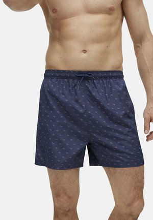 Bañador navy con cintura de cordón, que presenta un patrón geométrico pequeño repetido en rosa y blanco. Tejido ligero y suave.