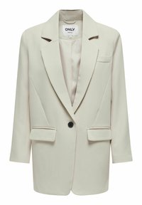 Blazer strutturato beige con un singolo bottone nero, rever a punta, due tasche frontali e tessuto leggermente testurizzato.