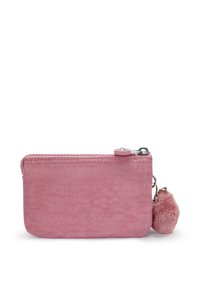 Roze canvas etui met een rits, ronde vorm, gestructureerd oppervlak en een afneembare pluizige pomponaccessoire.