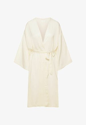 Jasno-beżowy kimono, wykonany z gładkiego materiału. Posiada szerokie rękawy, dekolt w kształcie V oraz przewiązywany pasek w talii, umożliwiający regulację dopasowania.