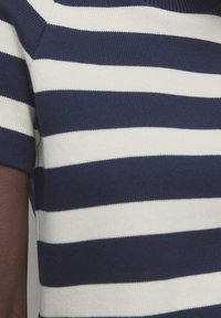 Navy and white striped knit top with a ribbed texture, featuring short sleeves and a crew neckline.