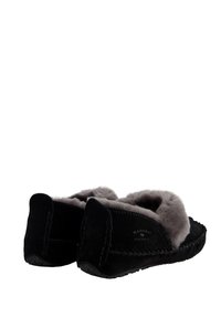 Zwarte suède slippers met grijze bontvoering, voorzien van een gestikt ontwerp, een platte zool en een logo dat op de hak is geperst.