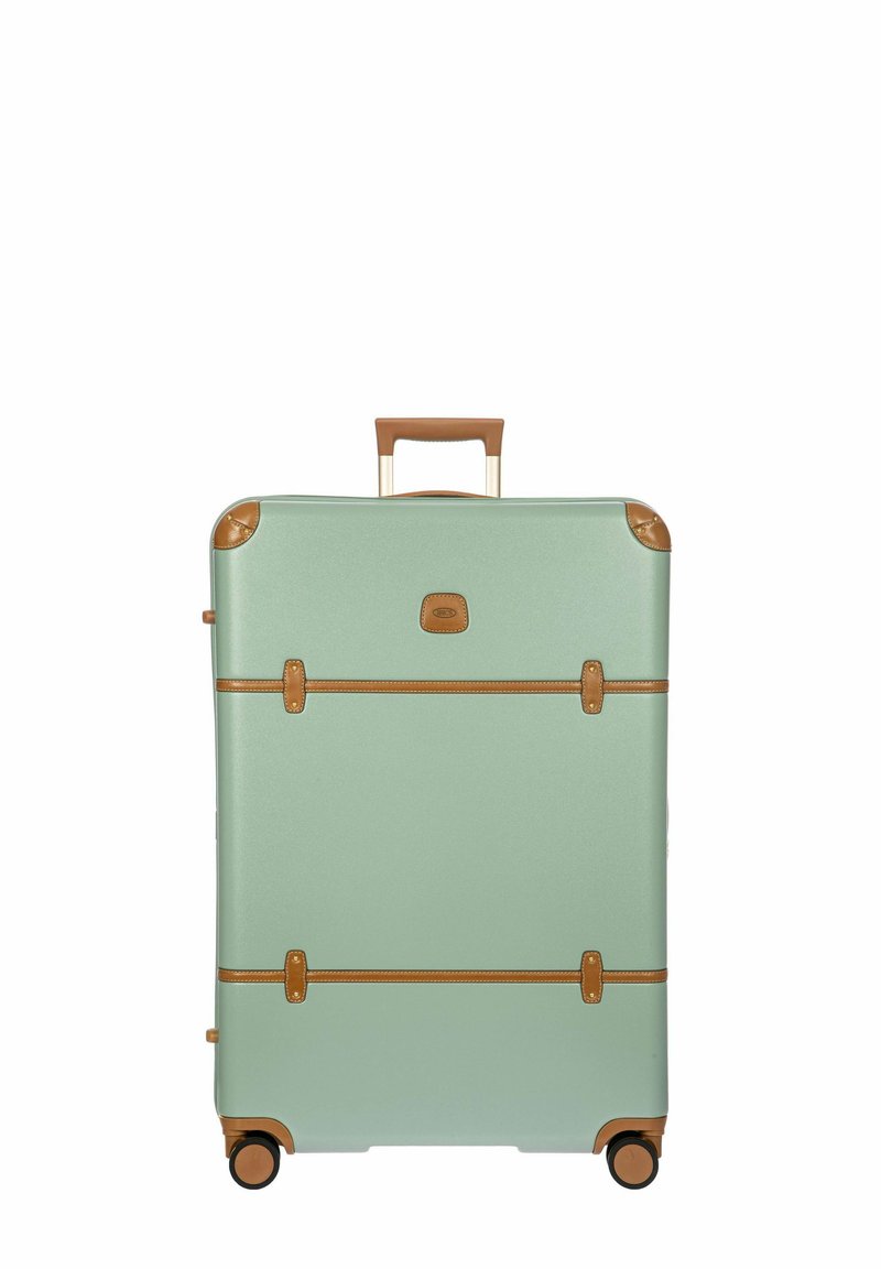 Maleta rígida color verde menta con detalles en cuero marrón, doble asa y cuatro ruedas para una fácil movilidad. Correas horizontales en la parte frontal.