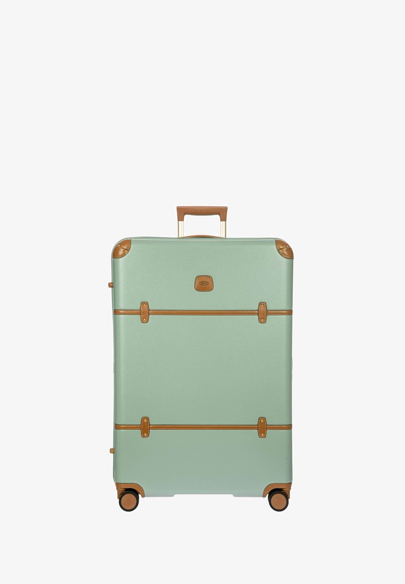 Maleta rígida color verde menta con detalles en cuero marrón, doble asa y cuatro ruedas para una fácil movilidad. Correas horizontales en la parte frontal.