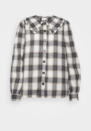 Blusa de mangas longas xadrez em creme, azul-marinho e castanho, com um grande colarinho volumoso, frente com botões e punhos franzidos.