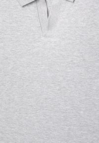 Grå polo-shirt lavet af tekstureret stof, med klassisk krave og knaplukning. Enkel design uden yderligere mønstre eller accenter.