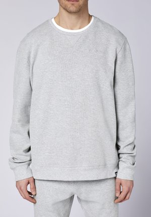 Gray sweatshirt with ribbed texture, round neckline, and long sleeves. Features a logo in tonal embroidery on the chest and matching hem.