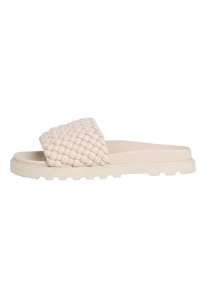 Beige slide sandal with thick, cushioned sole and wide, woven strap across the top for foot support and style.