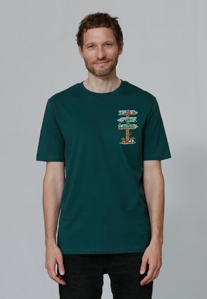 Teal cotton t-shirt featuring a colorful graphic of signposts with nature motifs on the left chest area. Crew neck and short sleeves.