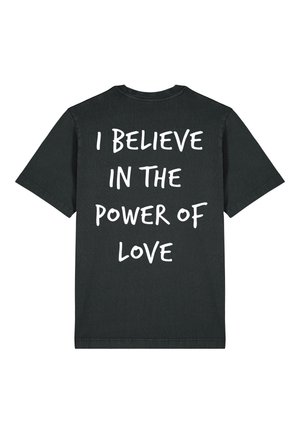 Black cotton t-shirt featuring short sleeves and a relaxed fit. The back displays large white text reading, "I BELIEVE IN THE POWER OF LOVE."